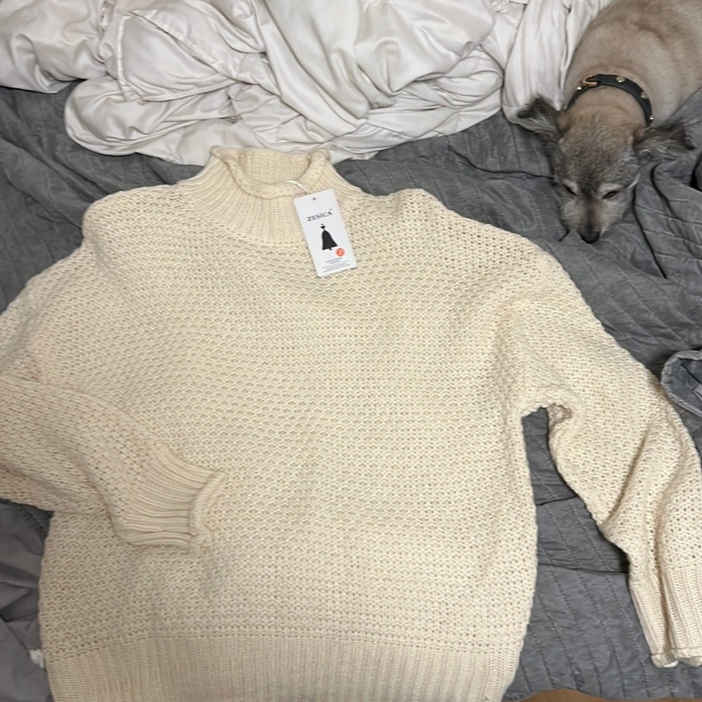 Crème knit sweater with rolled hems